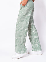 Pantalones anchos con diseño de frondas decorativas de Happy Earth